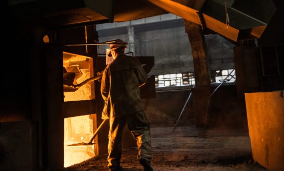 Steelworker at work near the working arc furnace